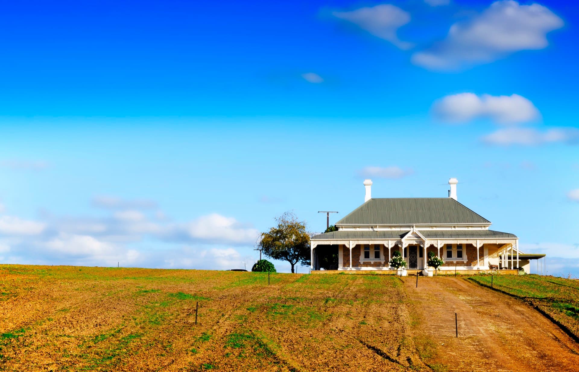 Australian homestead with a wide verandah under a blue sky